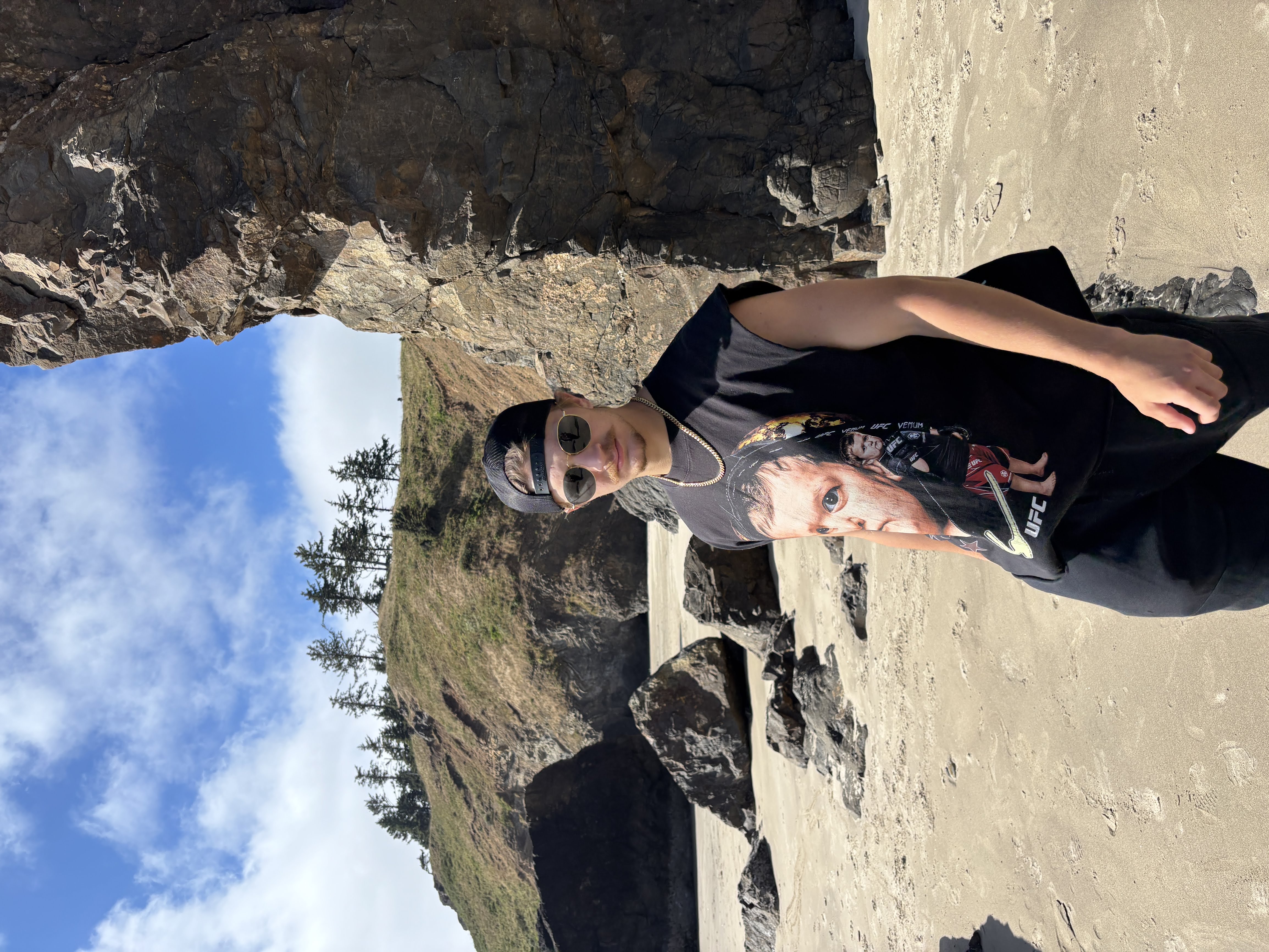 Oliver enjoying the coast, with the ocean and cliffs in the background.